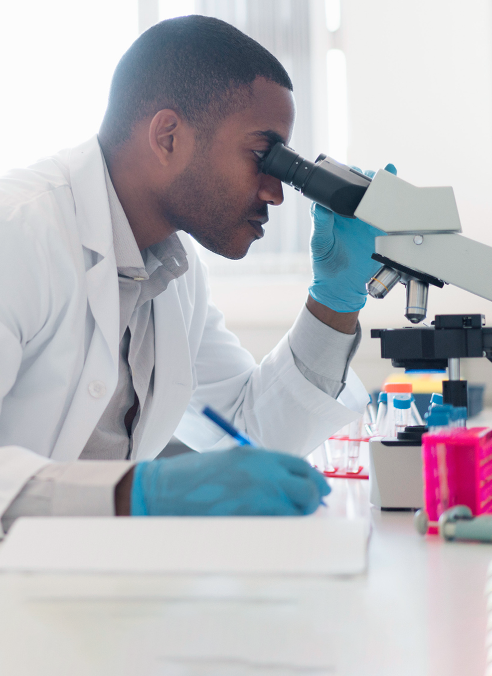 researcher using microscope